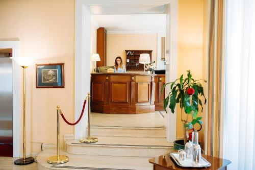 a woman is standing in theoyer of a house at Hotel Villa Traiano in Benevento