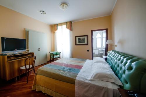 a hotel room with a bed and a flat screen tv at Hotel Villa Traiano in Benevento