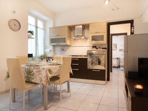 a kitchen and dining room with a table and chairs at Nel centro storico di Ovada in Ovada