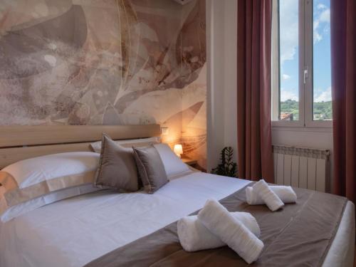 a bedroom with a bed with two towels on it at Nel centro storico di Ovada in Ovada