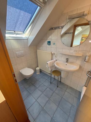 a bathroom with a sink and a toilet at Hotel Friesenhof in Westoverledingen