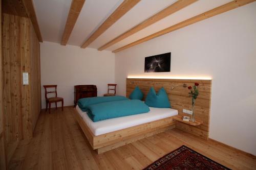 a bedroom with a bed, desk, and lamp at Apartments Im Winkl in Brunico