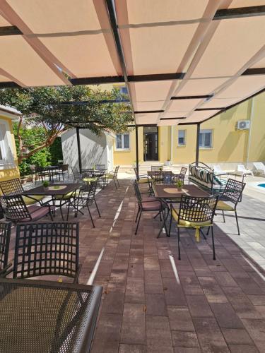 an empty outdoor patio with tables and chairs at Villa Iva-Dom in Kaštela