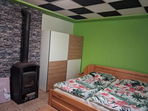 a bedroom with a bed and a wood stove at Žamberk-apartmán líšnice in Žamberk