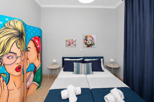 a bedroom with a bed with a painting on it at Pipetos house in Acharavi