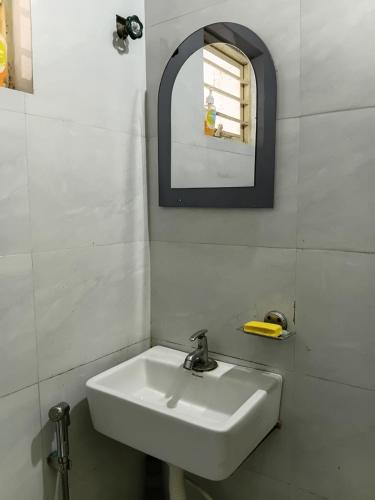 a bathroom with a white sink and a mirror at Nasa Hostel in Panchanai