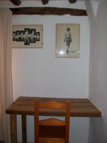 a wooden table and a picture of a boy on a wall at Luna11 in Alcañiz