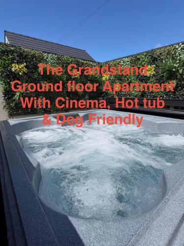 a sign that reads the grand island ground floor apartment with china hot tub at Swish Luxury Holiday Apartments in Blackpool