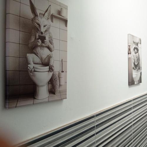 a bathroom with a statue of a bunny sitting on a toilet at GuestHouse Gentile Caruso in Torrenova