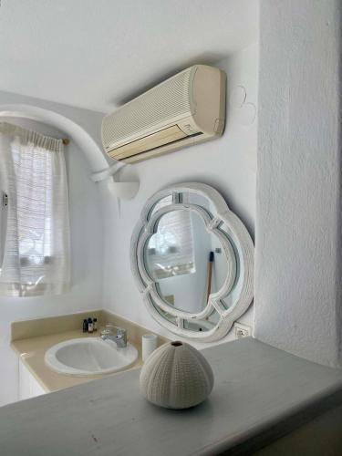 a bathroom with a sink and a mirror on the wall at Maria Elena - Suite Home in Mikonos