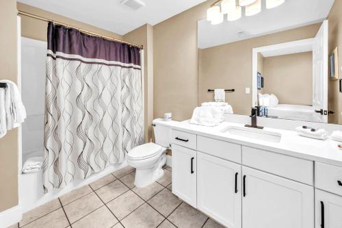 a bathroom with a sink and a toilet and a shower at Laketown Wharf 903 in Panama City Beach