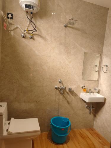 a bathroom with a toilet and a sink at Hotel DG Residency in Guwahati