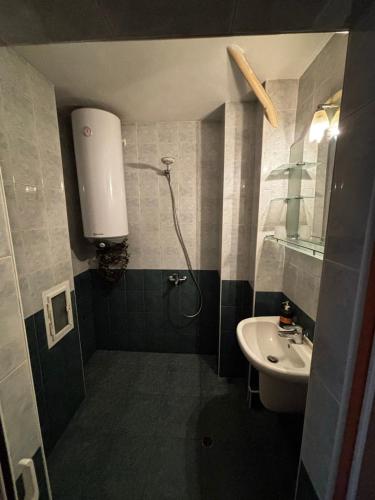 a bathroom with a shower and a sink at Голям двустаен апартамент in Burgas