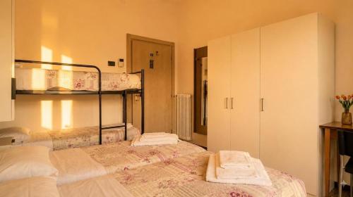 a bedroom with two bunk beds with towels on them at Villa Emma in Nago-Torbole