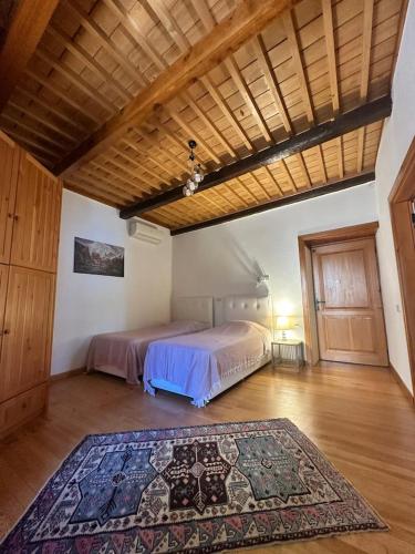 a bedroom with two beds and a rug on the floor at Villa Historyka in Alanya