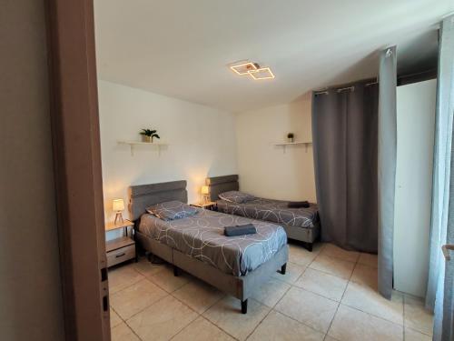 a bedroom with two beds in a room at Maison de campagne in Aubagne