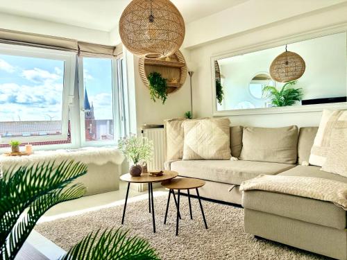 a living room with a couch and a table at BEACH apartment met directe toegang tot het STRAND ! in Knokke-Heist