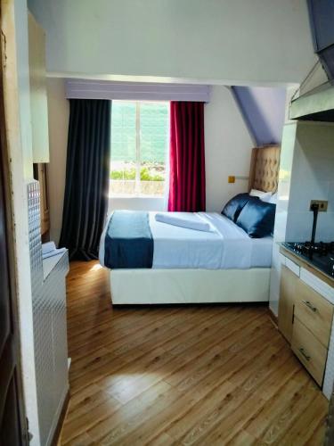 a bedroom with two beds and a window at Marine waters retreat Block A in Embu