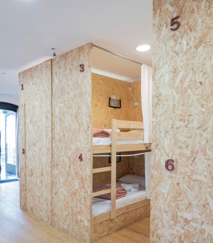a room with two bunk beds in a wall at HOSTEL NAMOR in Ribadeo