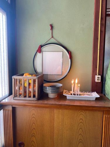 a vanity with a mirror and candles on it at Inn Omishima in Imabari