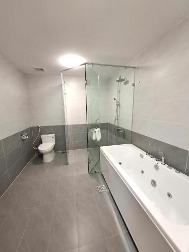 a bathroom with a shower and a tub and a toilet at Army Hotel in Yen