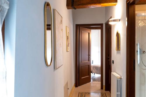 a hallway with a door and a mirror at TUSCANFLAT Castle in Scrofiano