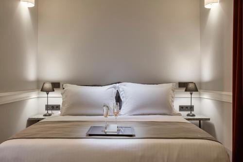 a bedroom with a bed with two glasses on a tray at The Zillers Boutique Hotel in Athens
