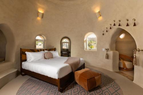 a bedroom with a bed and a bathroom with a tub at Sandora Domes - Architectural Retreat Near National Park in Joshua Tree