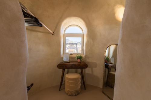 a small bathroom with a table and a window at Sandora Domes - Architectural Retreat Near National Park in Joshua Tree