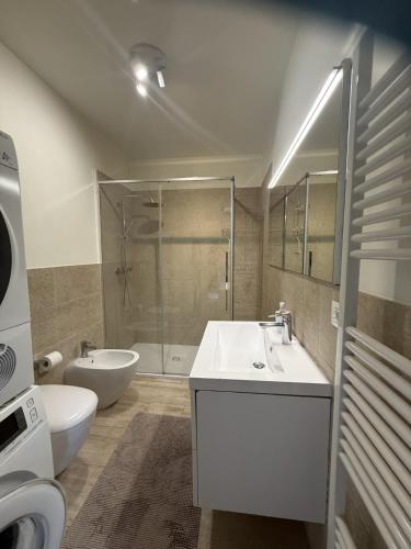 a bathroom with a sink and a toilet and a shower at Amadeus Apartment: a due passi dal Duomo in Treviso