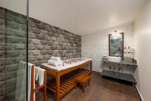 a bathroom with a counter and a sink in it at Fort JadhavGADH -A GADH Heritage Hotel in Pune