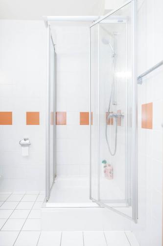 a shower with a glass door in a bathroom at Grand Rue Studio - sleeps 5 in Luxembourg