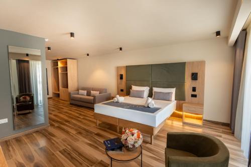 a large bedroom with a large bed and a couch at C'est La Vie Hotel Marsascala in Marsaskala