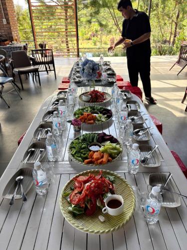 a long table with plates of food on it at Lang Omm in Tang Klang