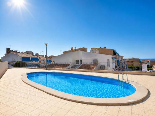 a swimming pool in the middle of a tiled yard at Penthouse with Panoramic View Santa Pola in Santa Pola