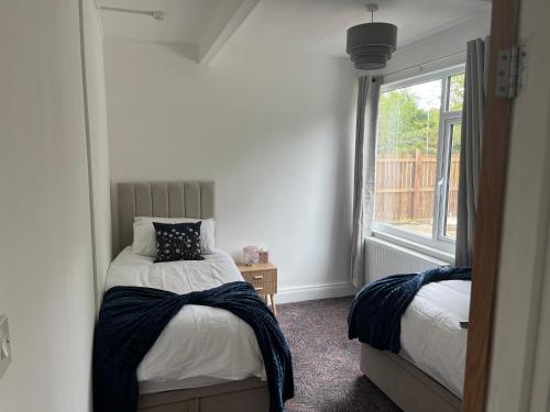 a bedroom with two beds and a window at Beamish Lodge in Stanley