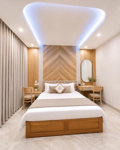 a bedroom with a large bed and a mirror at Hotel Bình Hải in Trương Tần