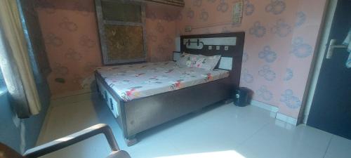 a small bed in a doll house bedroom at Hotel KANHA in Karauli