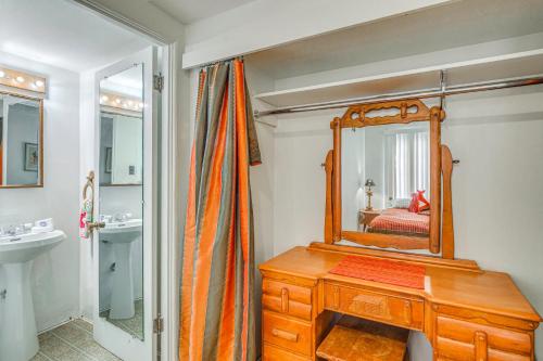 a bathroom with a wooden dresser and a mirror at Highly Walkable Area! Charming Roswell Bungalow in Roswell