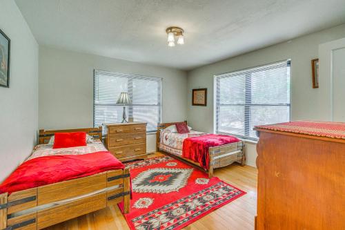 a bedroom with two beds and a dresser and windows at Highly Walkable Area! Charming Roswell Bungalow in Roswell