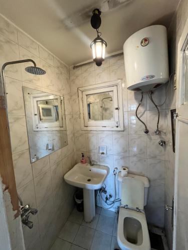 a small bathroom with a toilet and a sink at Nile View Studio Aswan in Aswan