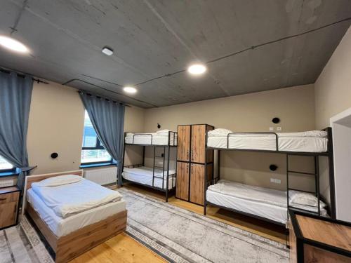 a room with three bunk beds in it at Hostel 78 in Karakol