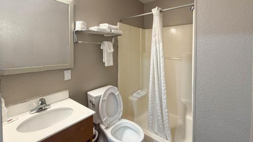 a bathroom with a toilet and a sink and a shower at Studio 6 Rancho Cordova, CA in Rancho Cordova