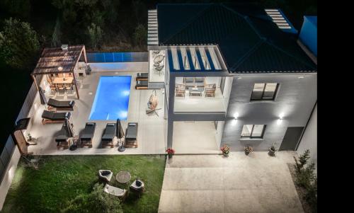 an aerial view of a house with a swimming pool at Villa Dreamscape - Elegant Stay with Private Pool by Villa Mana Gers in Planos