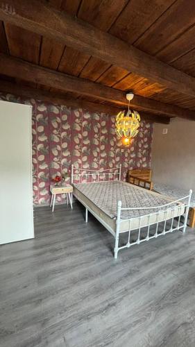 a bedroom with a bed and a chandelier at Guesthouse Story in Lagodekhi in Lagodekhi