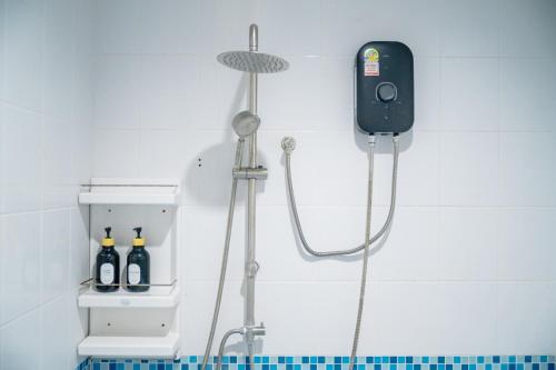 a shower in a bathroom with a shower head at Nan's 2 Bedroom House in Krabi