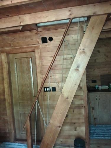 a set of stairs in a room with wooden walls at RIVERSTONE Drašković camp and bungalows in Nikšić