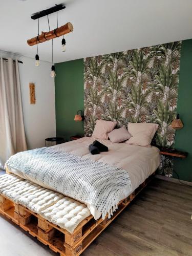 a bedroom with a bed made out of pallets at L'Orée du Bois in Pulnoy