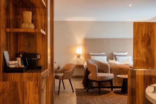 a hotel room with a bed and two chairs at Van der Valk Hotel Hollands Kroon in Wieringerwerf