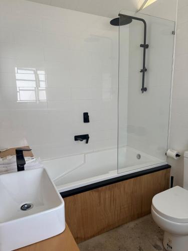 a bathroom with a shower and a sink and a toilet at Little Banks in Robe